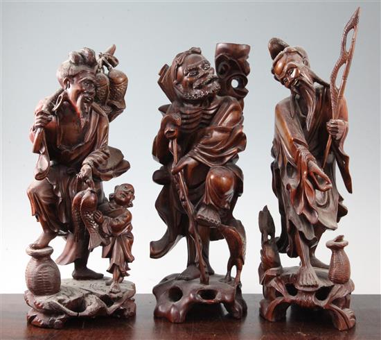 Three Chinese hardwood figures, mid 20th century, tallest 39cm